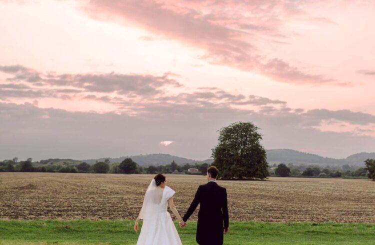 A couple walking into the sunset on their wedding day