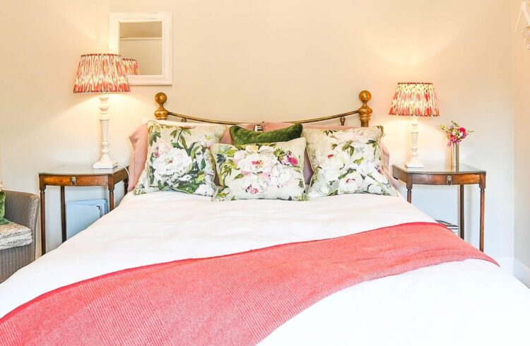 Bedroom at Morningside Cottage with bed, two bedside tables and chair visible