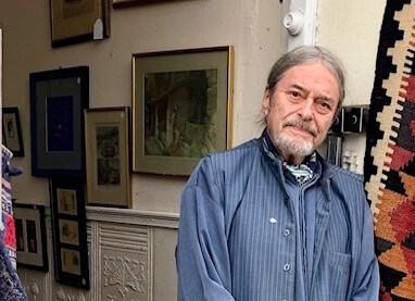 A person stands outside an antique shop