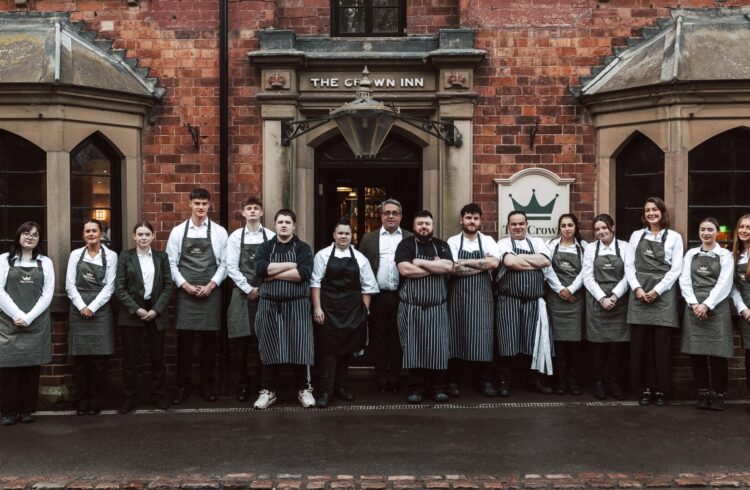 Staff of The Crown in uniform standing outside the pub