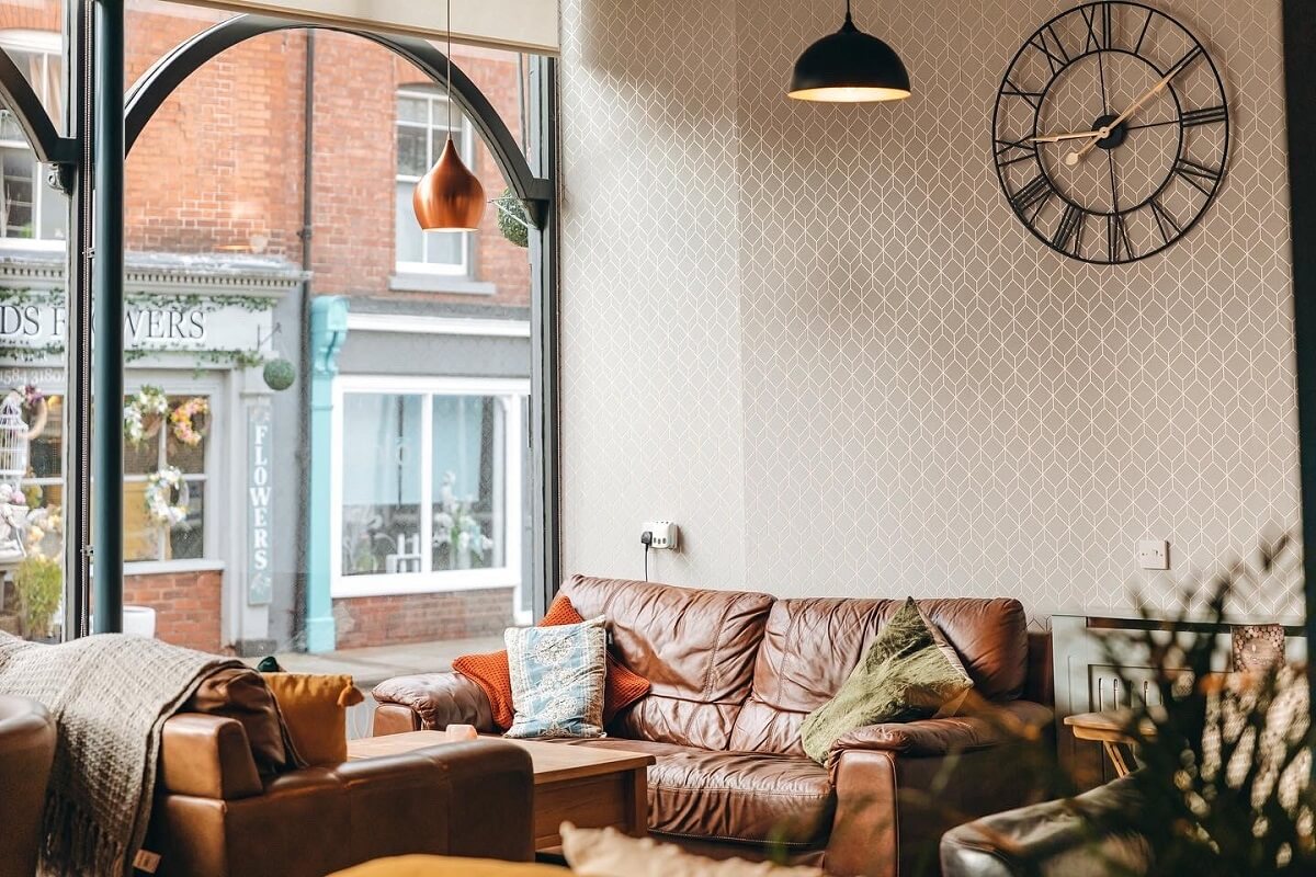 Seating area with sofas and view to street; large clock on wall